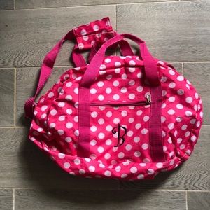 Pink and white polka dot “B” duffle bag with strap and front zipper small pocket